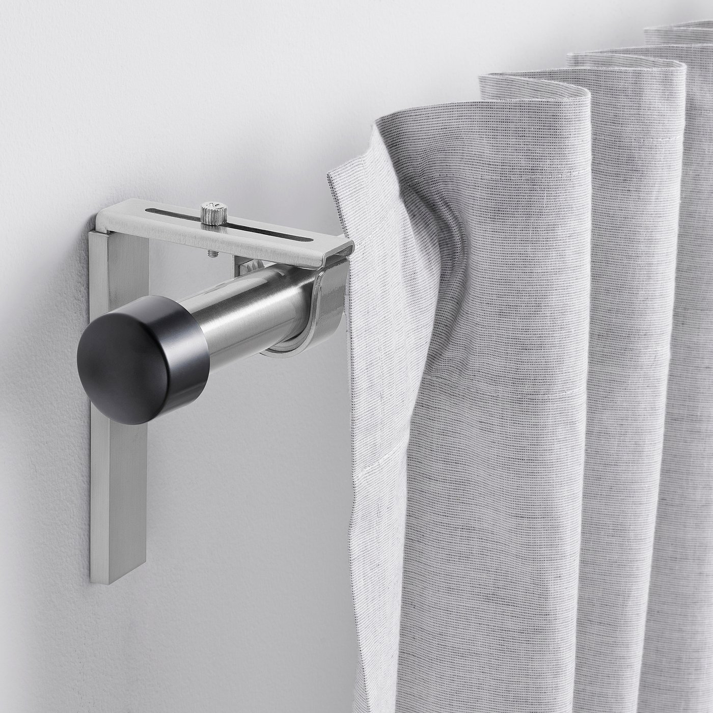 HUGAD silver curtain rod, modern design, adjustable length, attached to light-colored curtains.