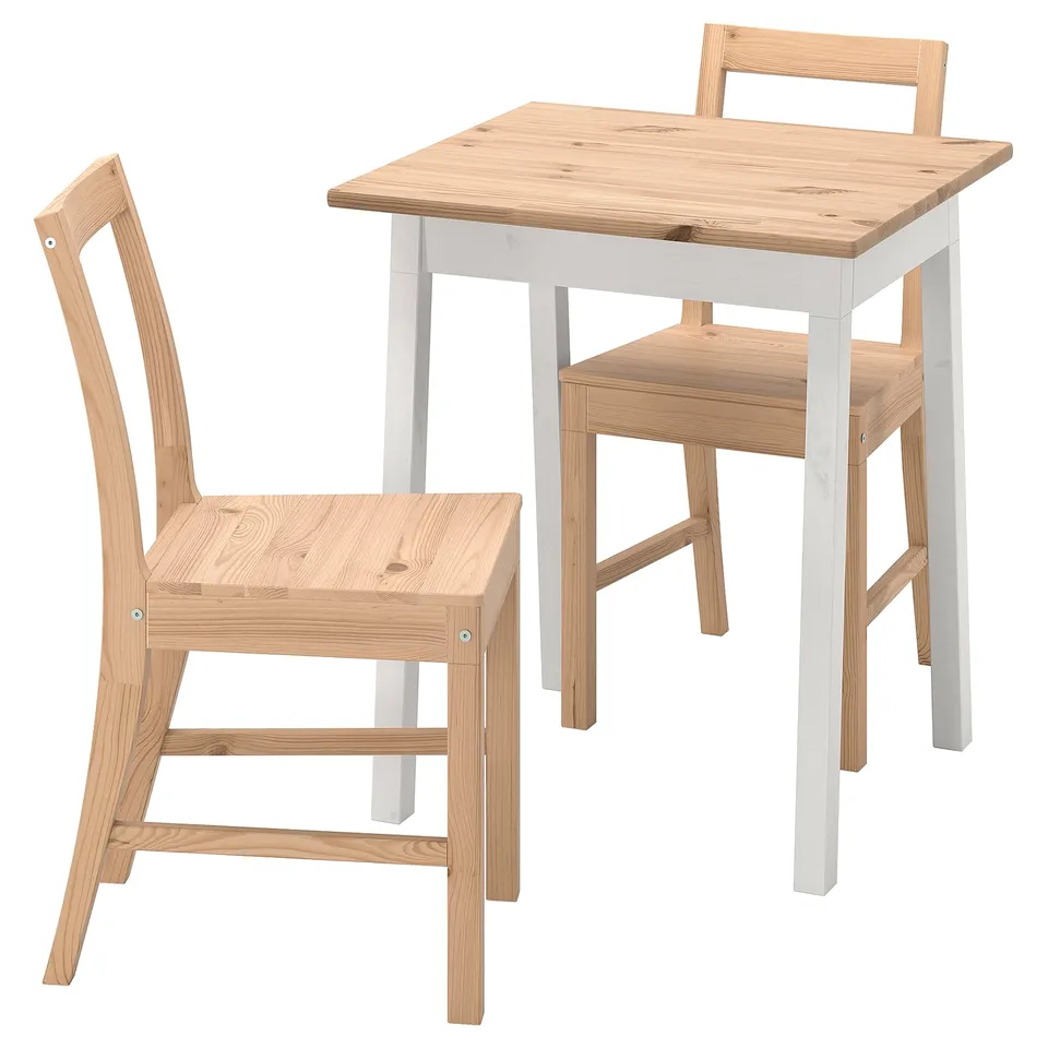 A wooden dining set called PINNTORP in light colours, made of solid wood, featuring a rectangular table and two matching chairs.