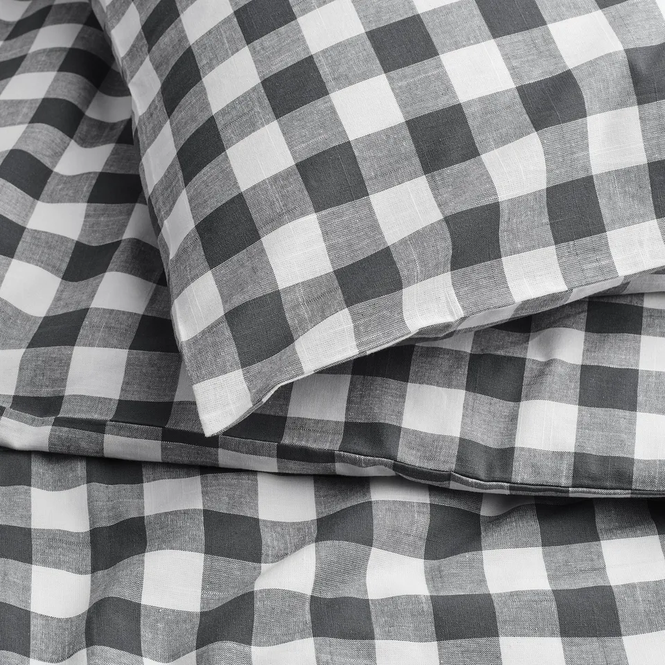 Black and white gingham check duvet cover, neatly folded, showcasing the patterns clarity and fabric texture.