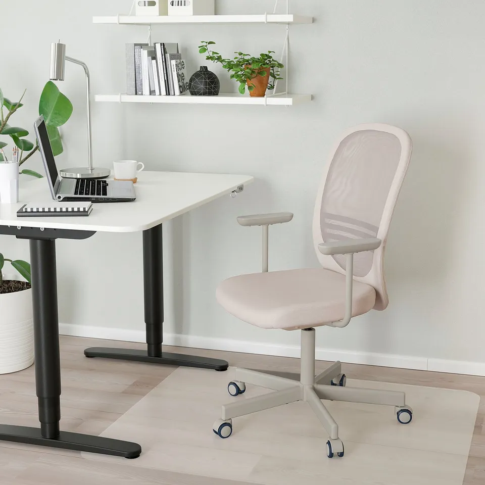 Modern home office with FLINTAN chair and adjustable desk.