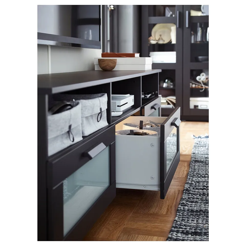 Black tv stand with pull-out bins and open storage shelves.