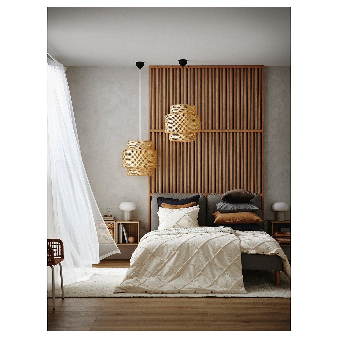 Modern bedroom with wooden floor, neutral bedding, wicker lampshades, and sheer curtains.
