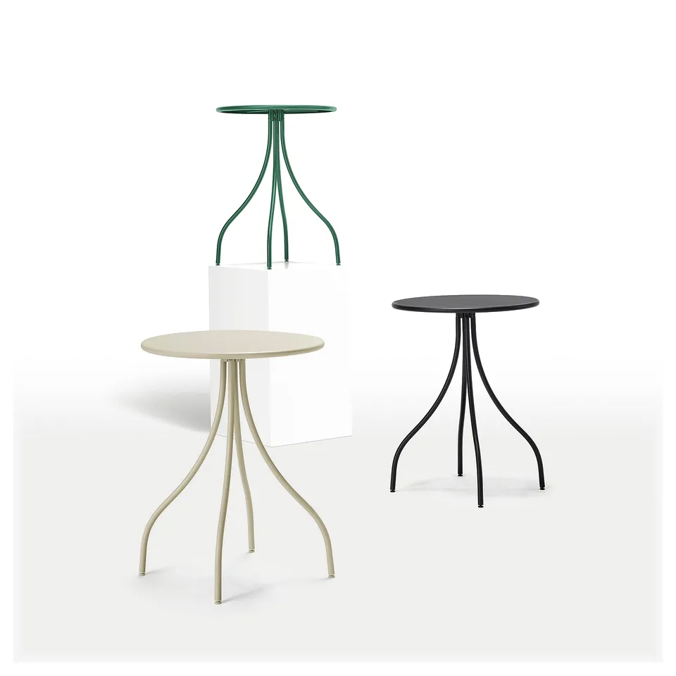 Three modern side tables in green, beige, and black, each with a round top and slim, angled legs, displayed against a white background.