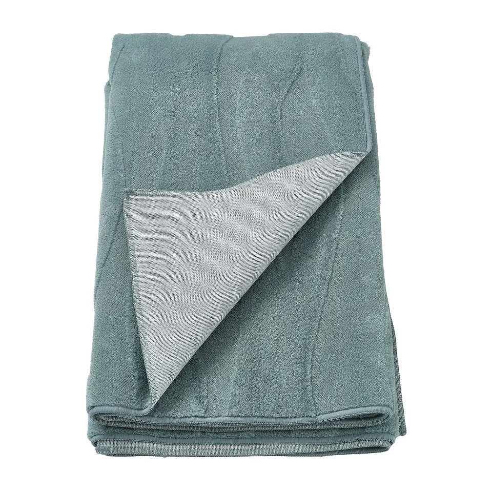 Folded green-blue recycled polyester rug with anti-slip backing, 3d-pattern.