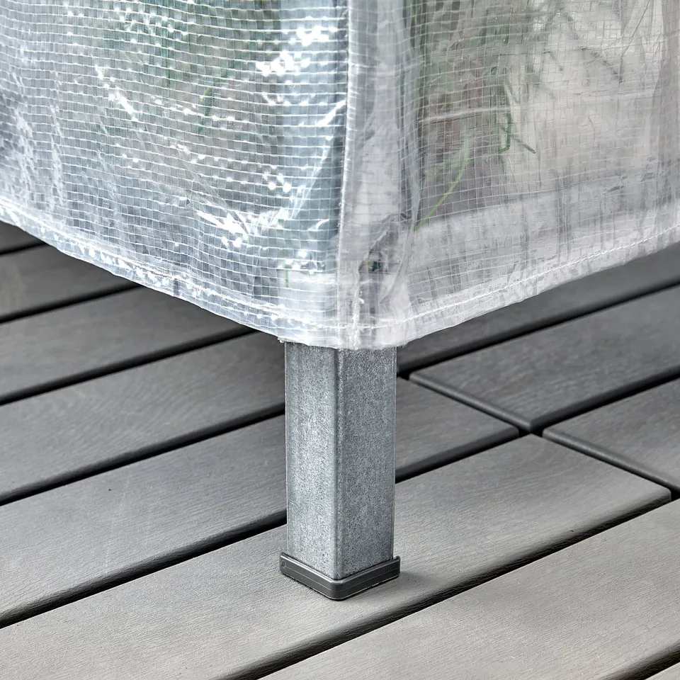 A shelving unit with a clear protective cover on a wooden deck, showcasing its dust-proof and air-circulating.