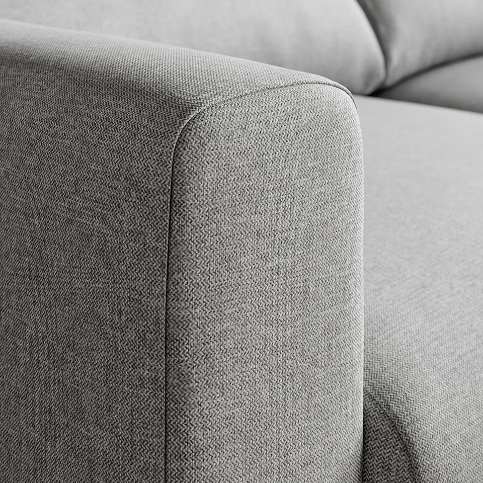 Close-up of a modern sofas armrest, showcasing sleek design and high-quality fabric.
