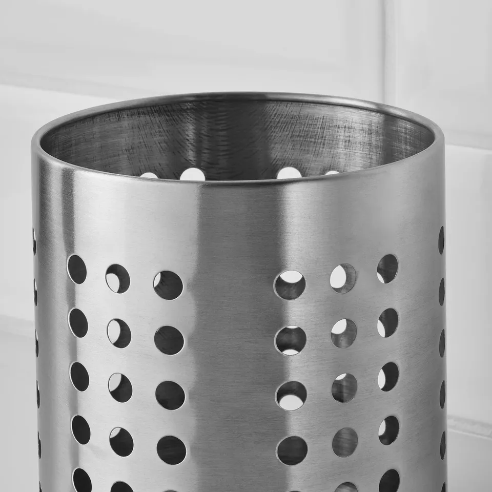Stainless steel kitchen accessory with perforated design ensures durability and easy cleaning.
