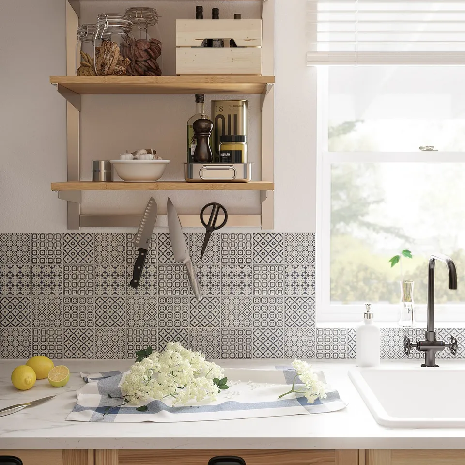 A stylish kitchen with a KUNGSFORS magnetic knife rack above a counter holding lemons and flowers.