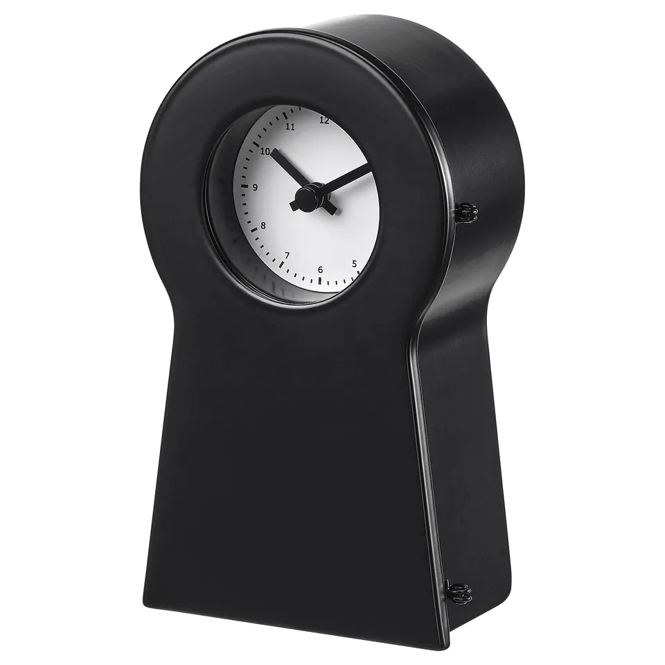 Black IKEA PS 1995 clock with white face, black hands, and steel body.