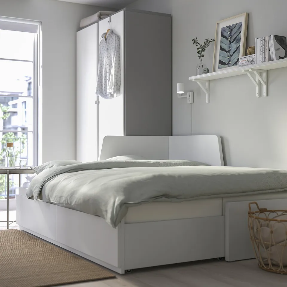 Modern, space-saving white daybed with storage drawers beneath, easily converts into a double bed for guests.
