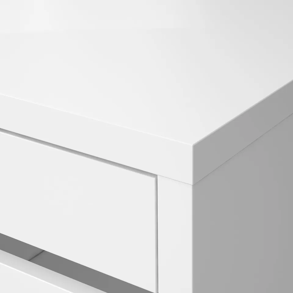Close-up of a sleek, white desk corner with smooth edges, showcasing modern, minimalist design and crisp finish.