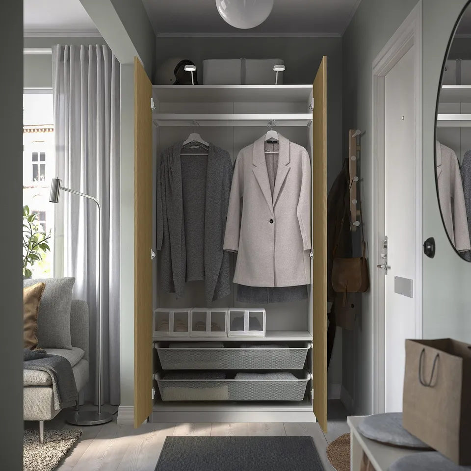 Open closet displaying clothes, with organised drawers and shelves, reflecting a tidy and functional storage space.