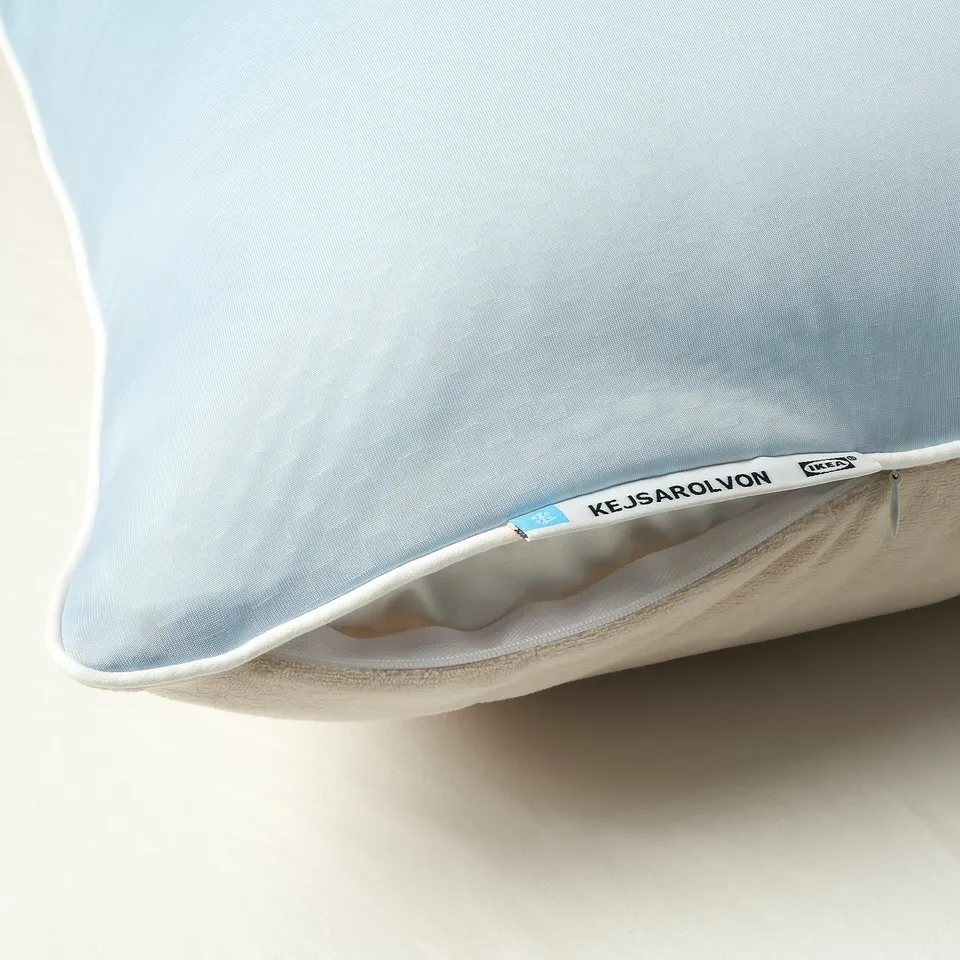 Light blue pillow protector with zipper; ikea brand tag visible.