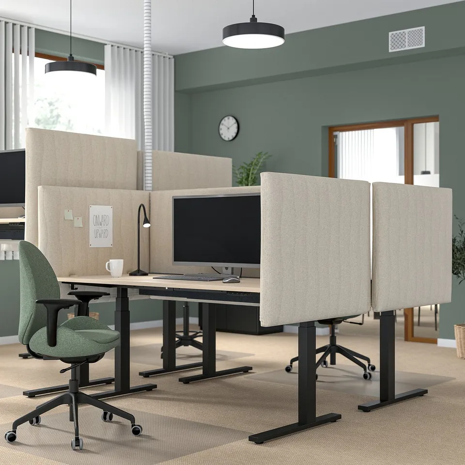 MITTZON sit-stand desks in office. Grey, modern design with dividers, ergonomic chairs, and large monitors. Wide, spacious layout.