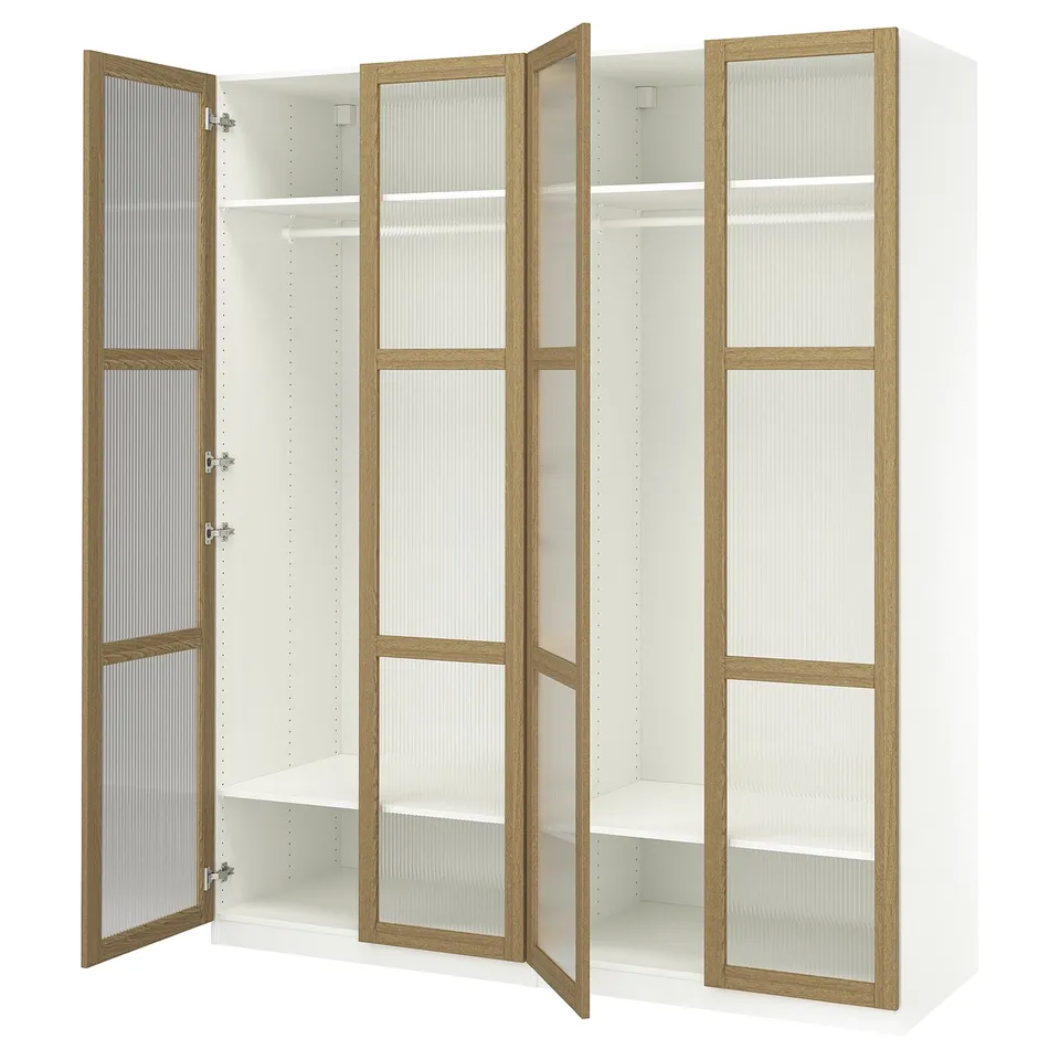 White ikea PAX wardrobe with glass doors and wooden frames, three open sections revealing adjustable shelves.