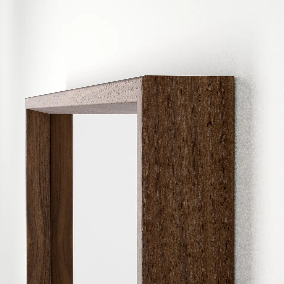 Modern wood-framed mirror with clean lines, mounted on a white wall.