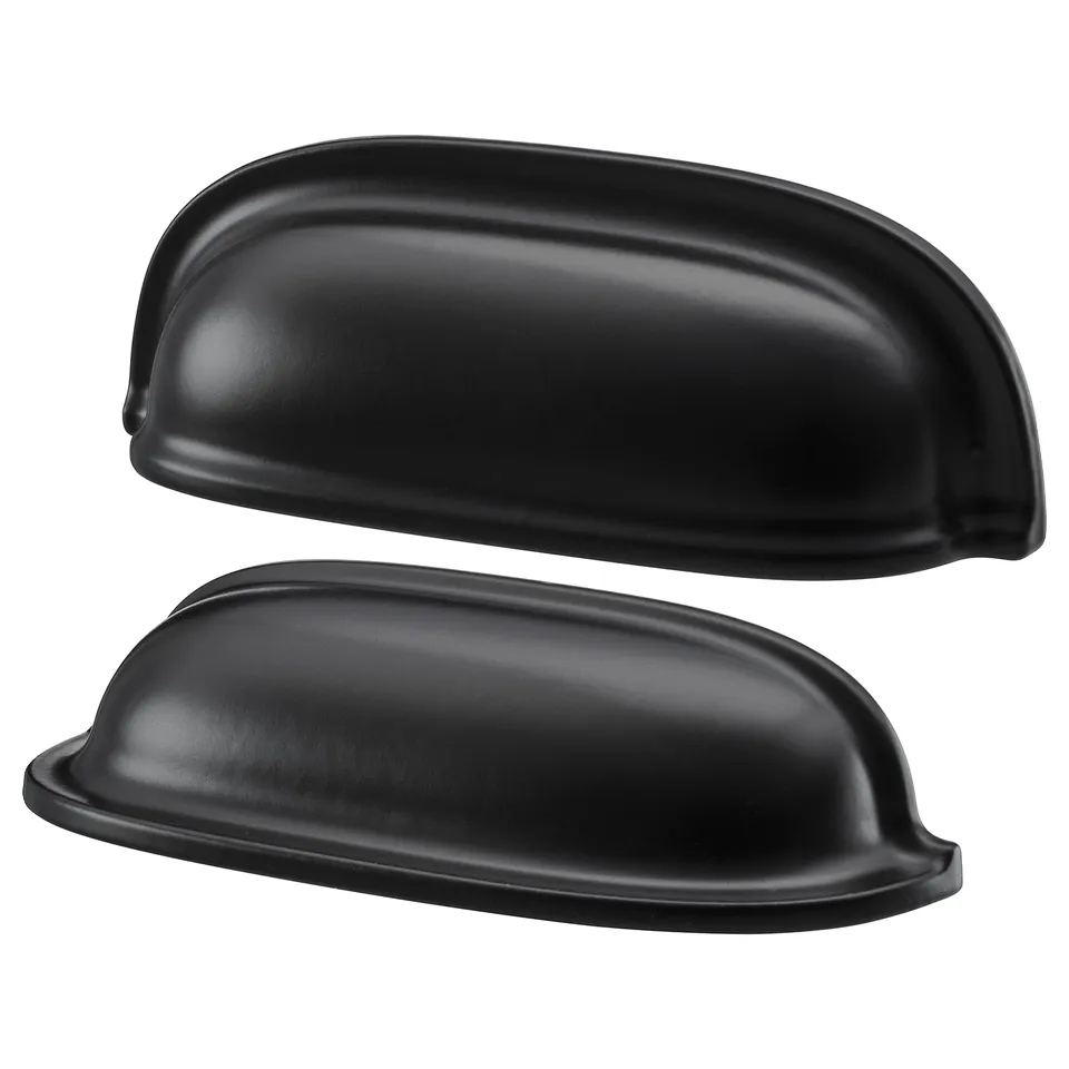 Two matte black, oval-shaped cup handles for cabinets, sleek and modern design.