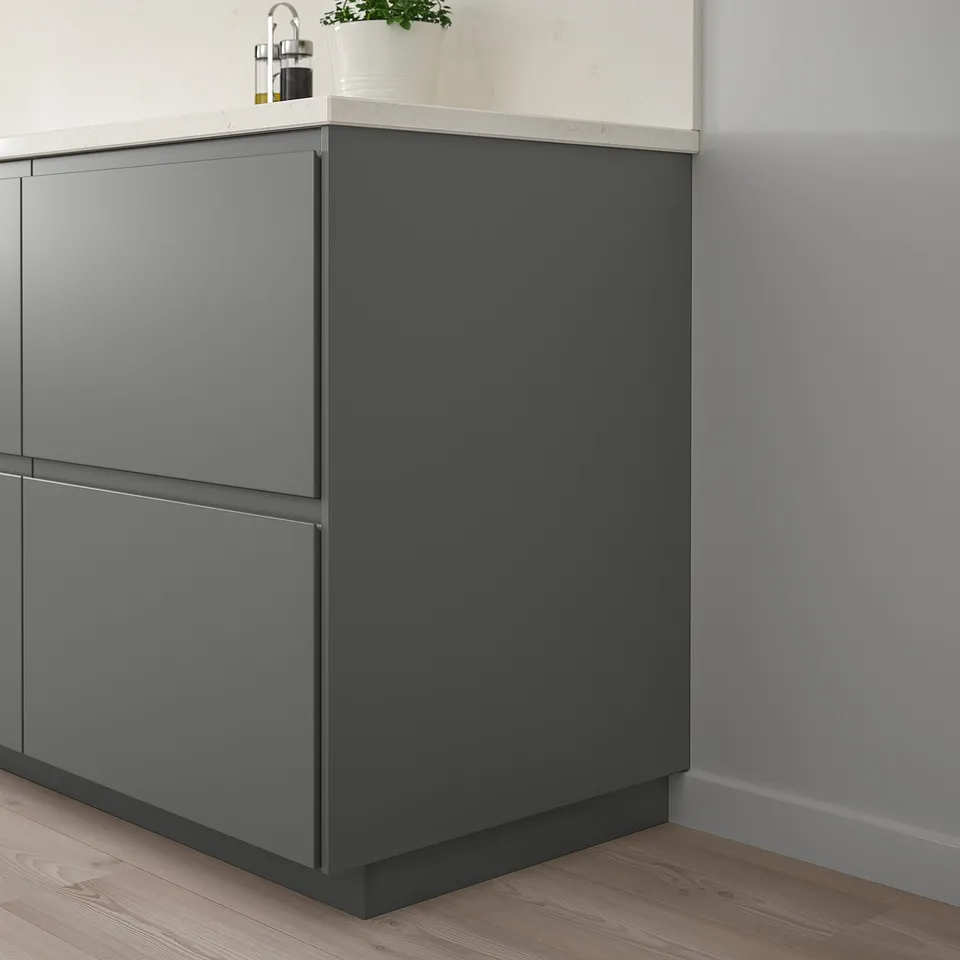 Grey FÖRBÄTTRA corner kitchen cabinet with plant.