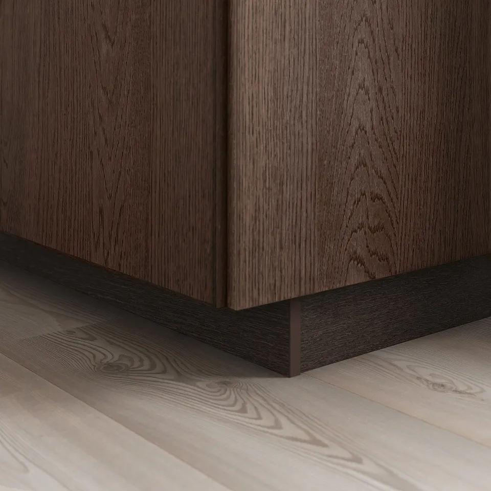Dark wooden kitchen cabinet base with visible grain pattern and solid oak edging, showcasing a modern design detail.