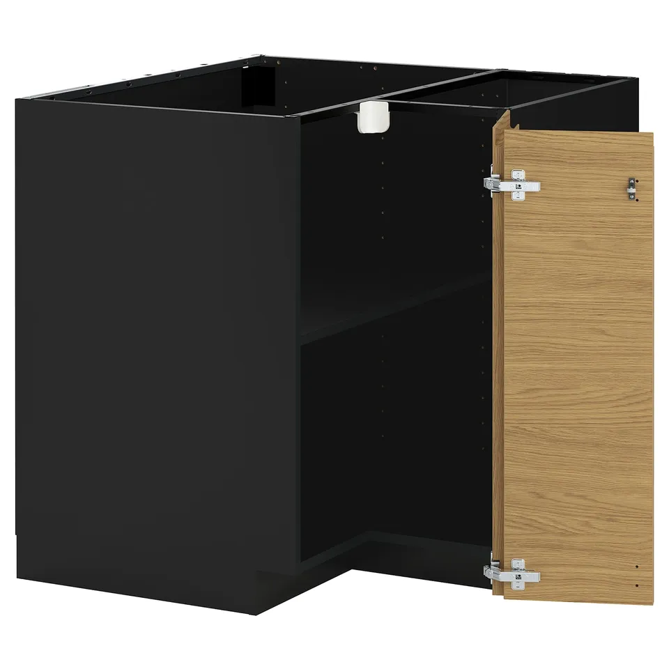 A black and oak ikea METOD kitchen unit with an open door.