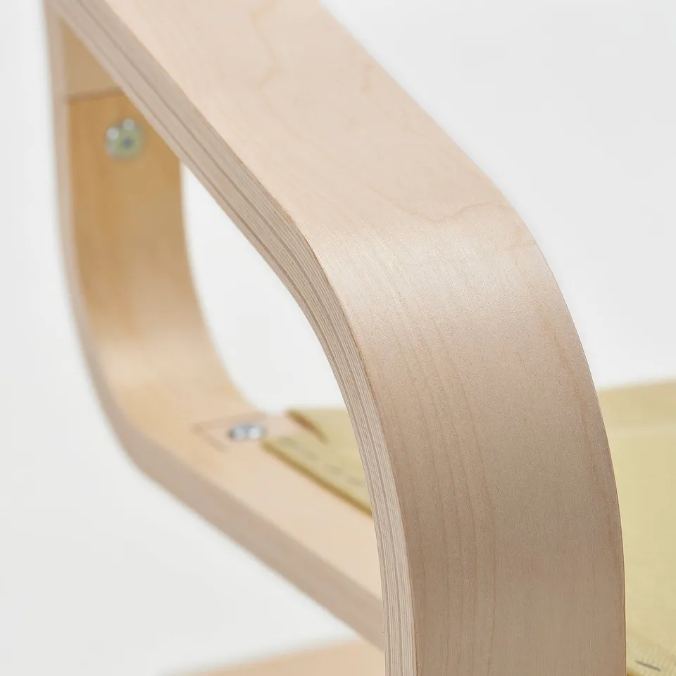 Curved wooden chair piece; smooth, light-colored finish; visible screws, high-quality craftsmanship.