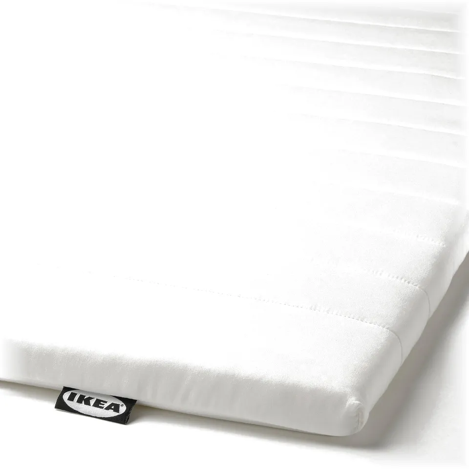 A white mattress pad by IKEA, neatly rolled, showcasing a smooth, quilted texture and a clean design.