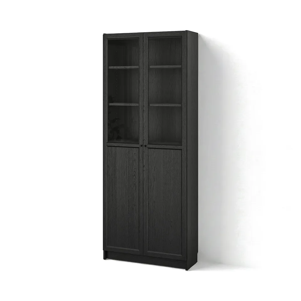 A black BILLY bookcase with glass doors, featuring a sleek, modern design and sturdy wooden structure.