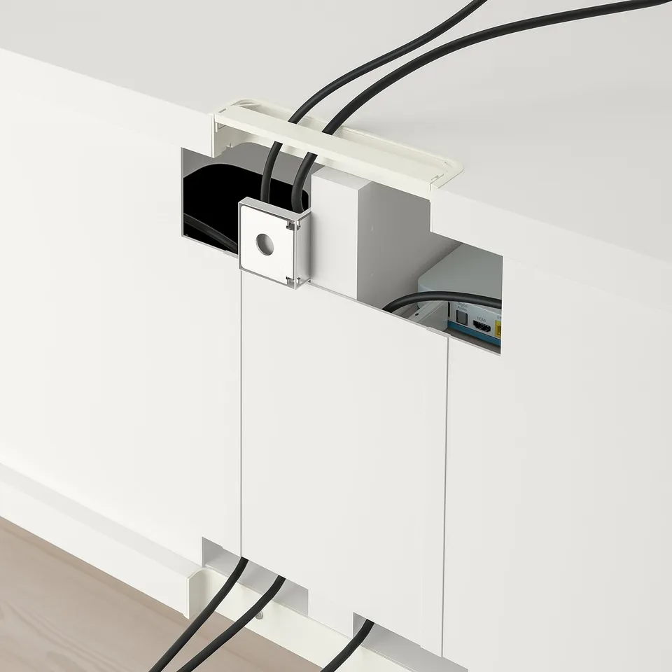 Cable management system in modern tv stand, showcasing organised cable routing and connexion hubs.