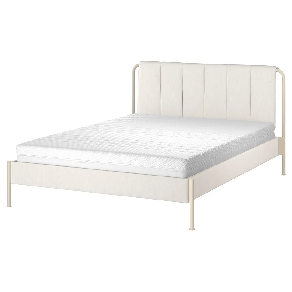 A TÄLLÅSEN bed in light beige with metal frames, a padded headboard, and a foam mattress.