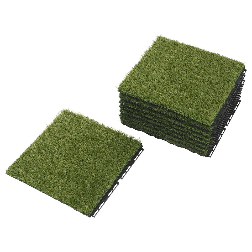 Two stacks of green artificial grass floor tiles in black frames.