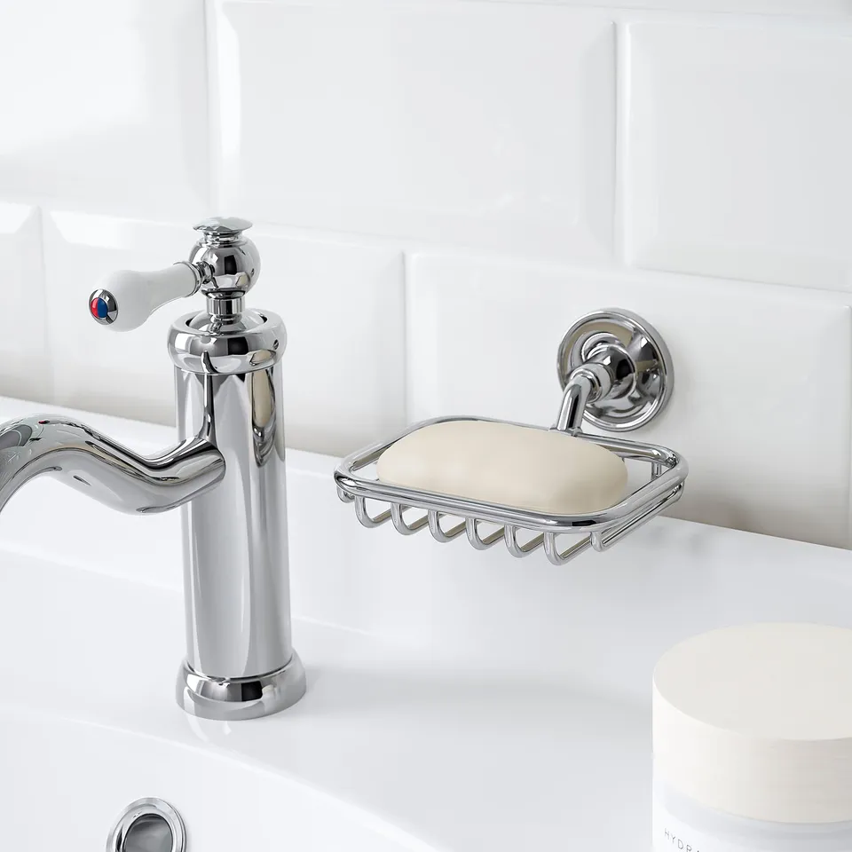 Chrome soap dish mounted beside sink, holding a bar of soap, part of BROFJÄRDEN series.