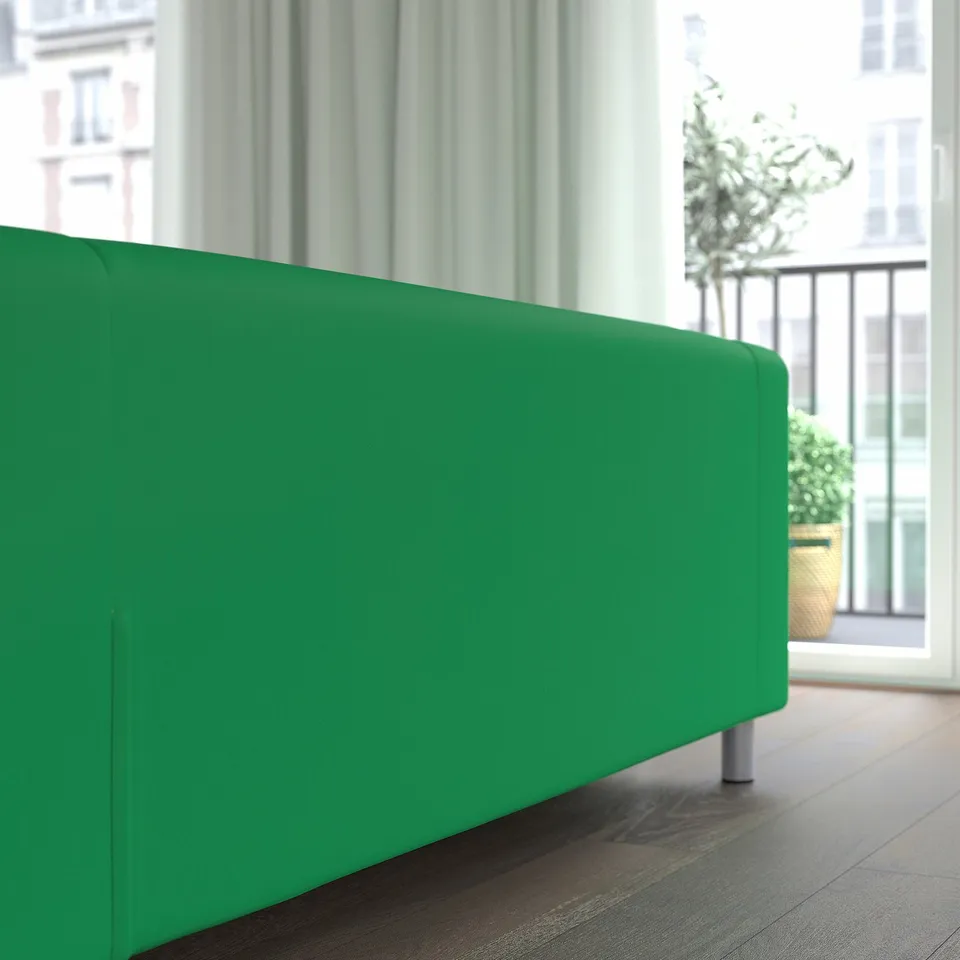 Modern green sofa by large window, sleek design, airy room, balcony