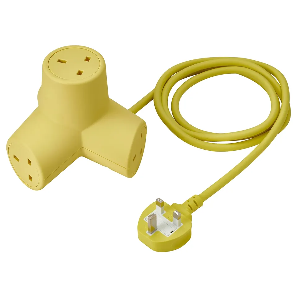 Yellow 4-way power cable with recycled housing, silicone pads, angled plug use, playful design.