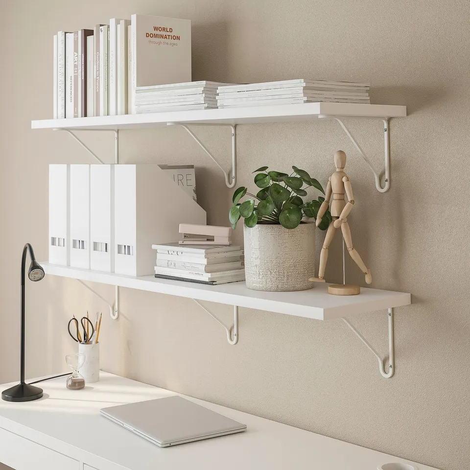 A white shelf holds books and a plant.