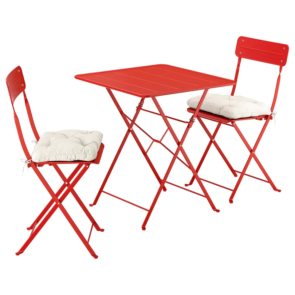 Bright red SUNDSÖ outdoor table and two chairs, foldable, modern design.