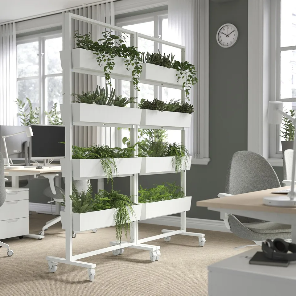 Office with a MITTZON plant divider: three shelves of greenery on wheels for space division and focus enhancement.
