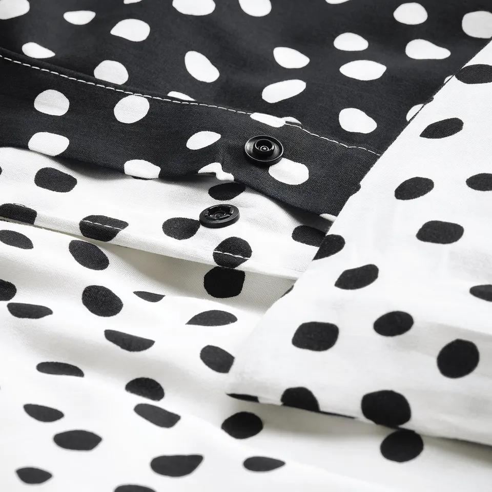 Black and white polka dot duvet cover with snap closure; soft, breathable fabric.