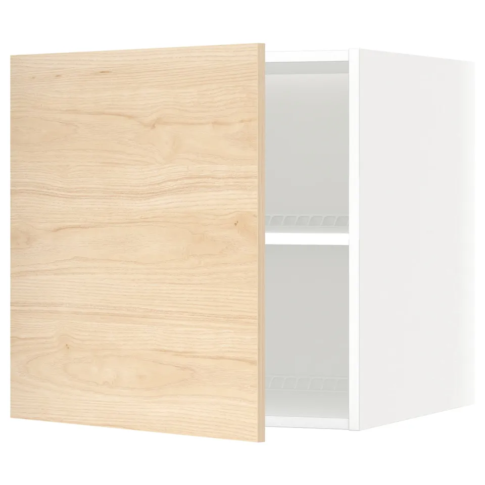 A white ikea METOD kitchen wall cabinet with a light ash wood-patterned door. Its rectangular, featuring an adjustable shelf inside.