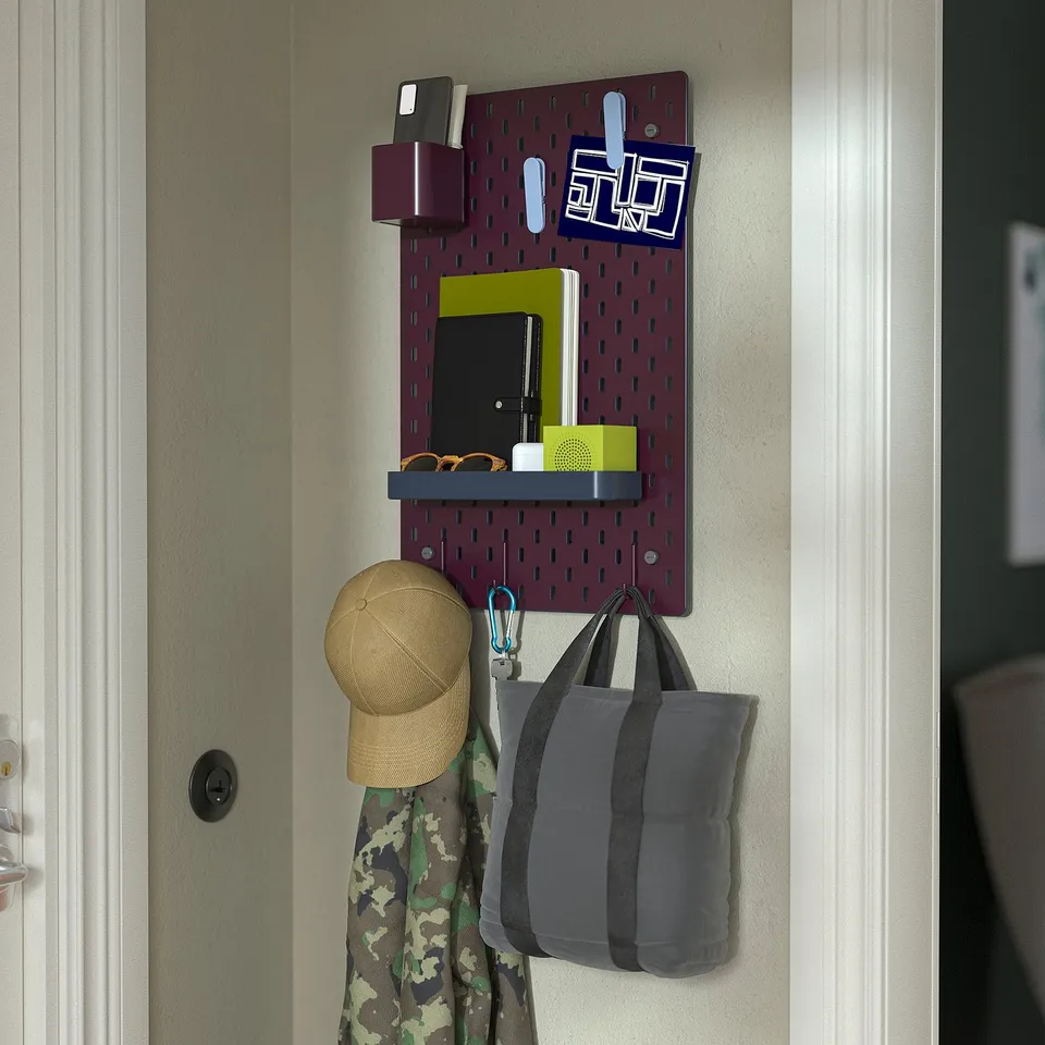 Pegboard organiser with hooks and pockets, holding a hat, bag, sunglasses, phone, and keys.