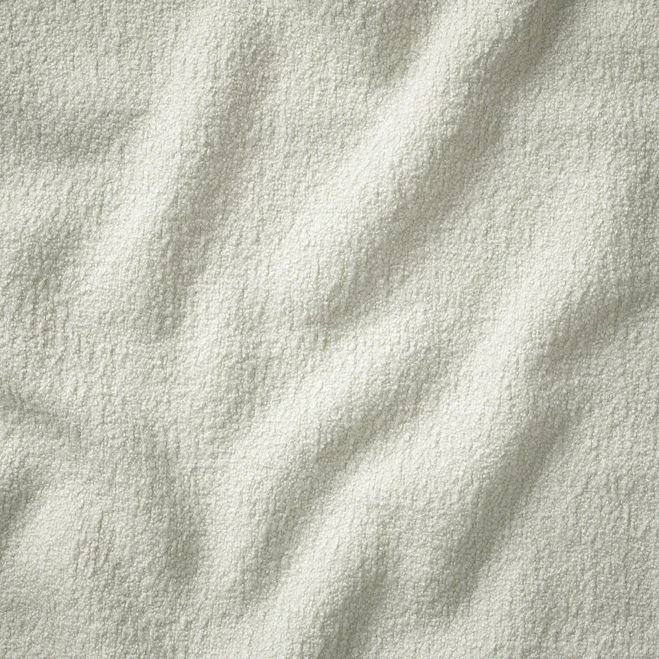 Close-up of a stylish, textured sofa cover, showcasing high-quality fabric with a luxurious, inviting appearance.