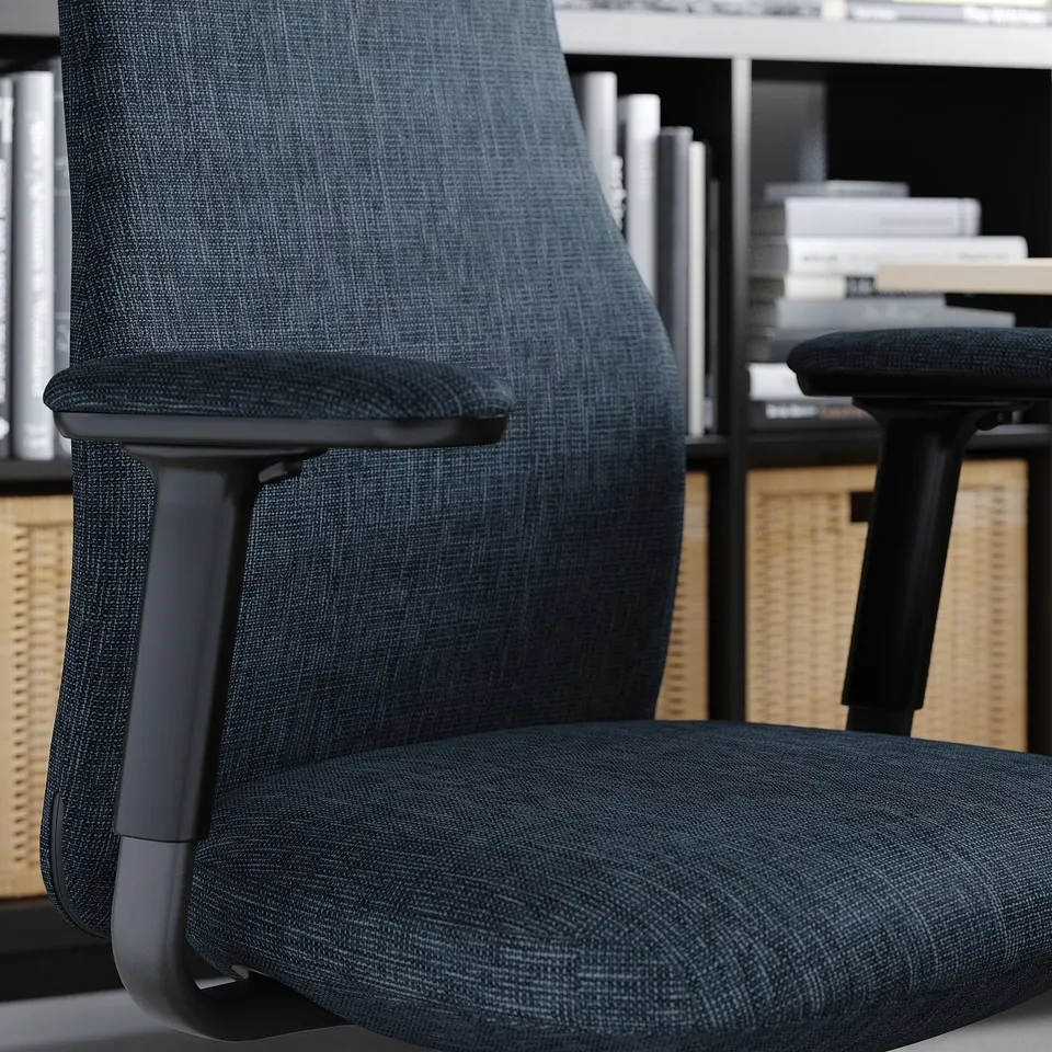 Dark grey adjustable office chair with armrests, in a modern workspace.