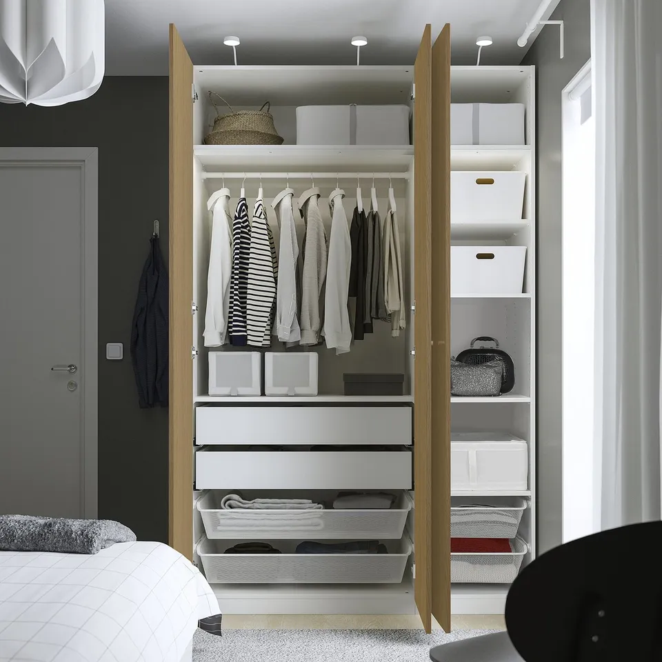 A well-organized wardrobe with folding clothes, storage bins, and drawers, efficiently utilising space.