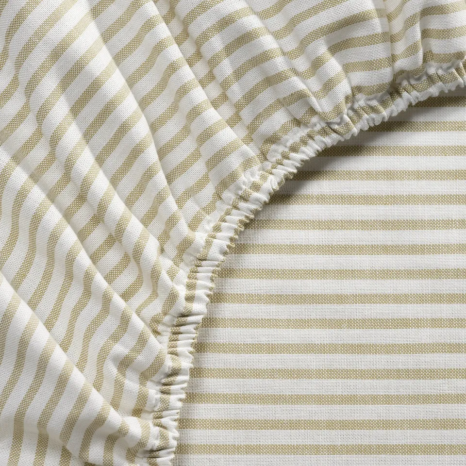 Beige and white striped fitted sheet with elastic edges, neatly woven.