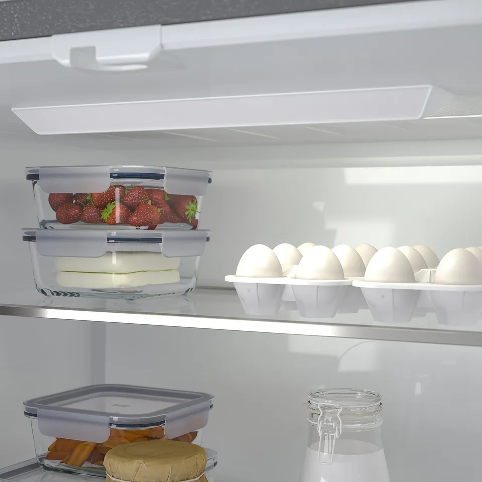 Fridge with variable temp drawer, showcasing strawberries, cheese, and eggs. Stacked clear containers seen.