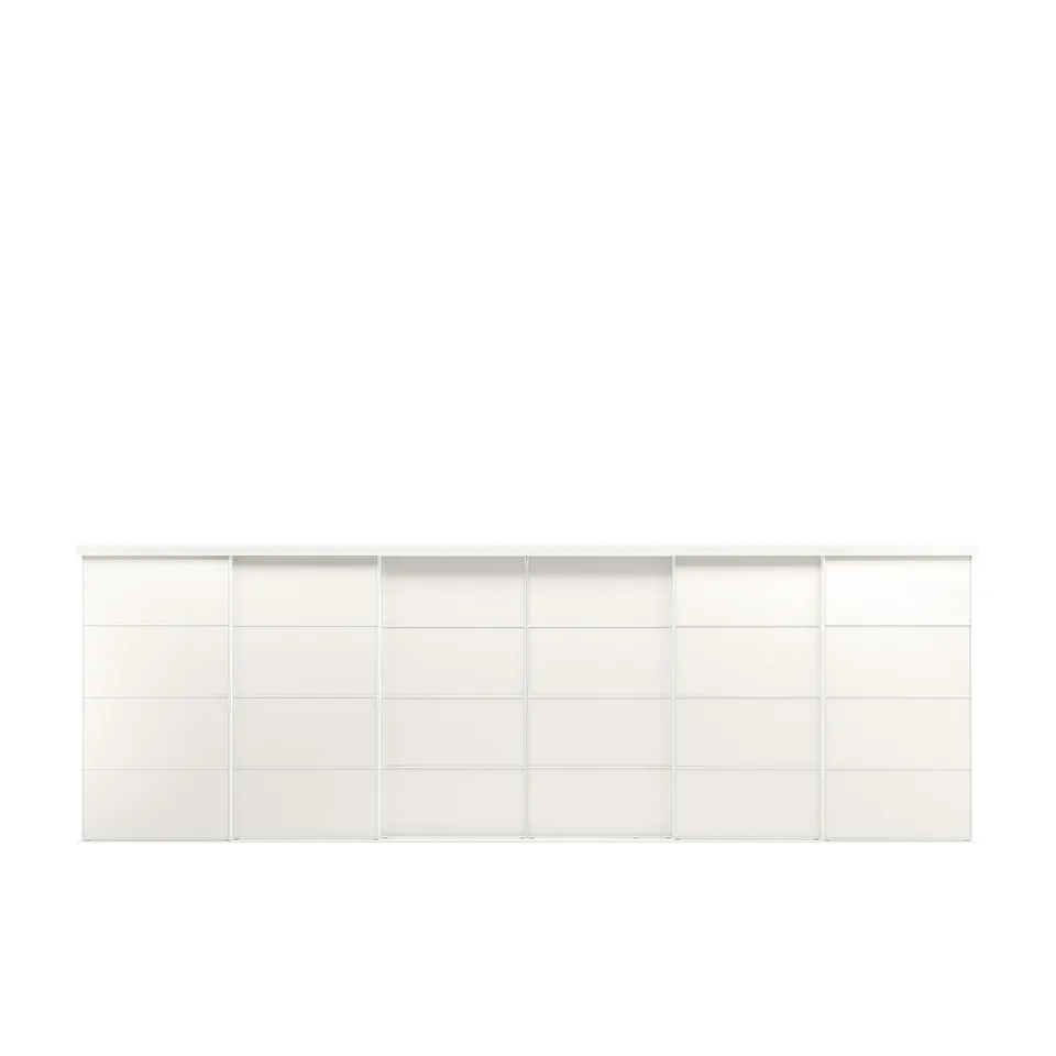 A white SKYTTA storage unit. It a minimalist design with multiple compartments and sliding doors. It is made of aluminium, fibreglass, and pine.