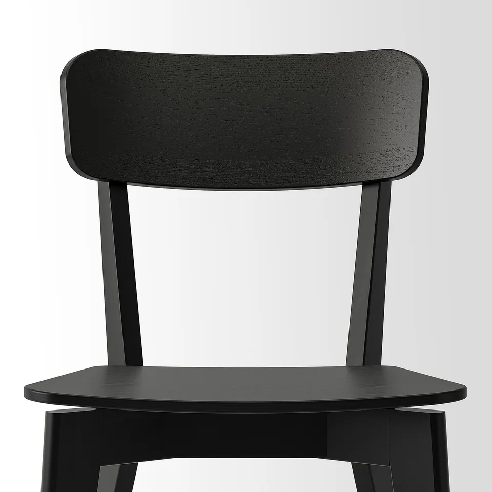 Black wooden chair with a smooth, sturdy design. A curved backrest and triangular seat base, showcasing quality craftsmanship. Ideal for modern decor.