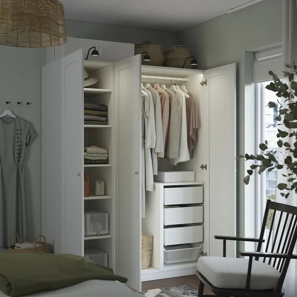 Modern wardrobe with open doors showing clothes and storage.