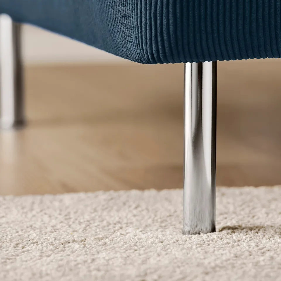 Sleek, modern sofa base, polished metal legs, plush blue seat, clean-lined design.