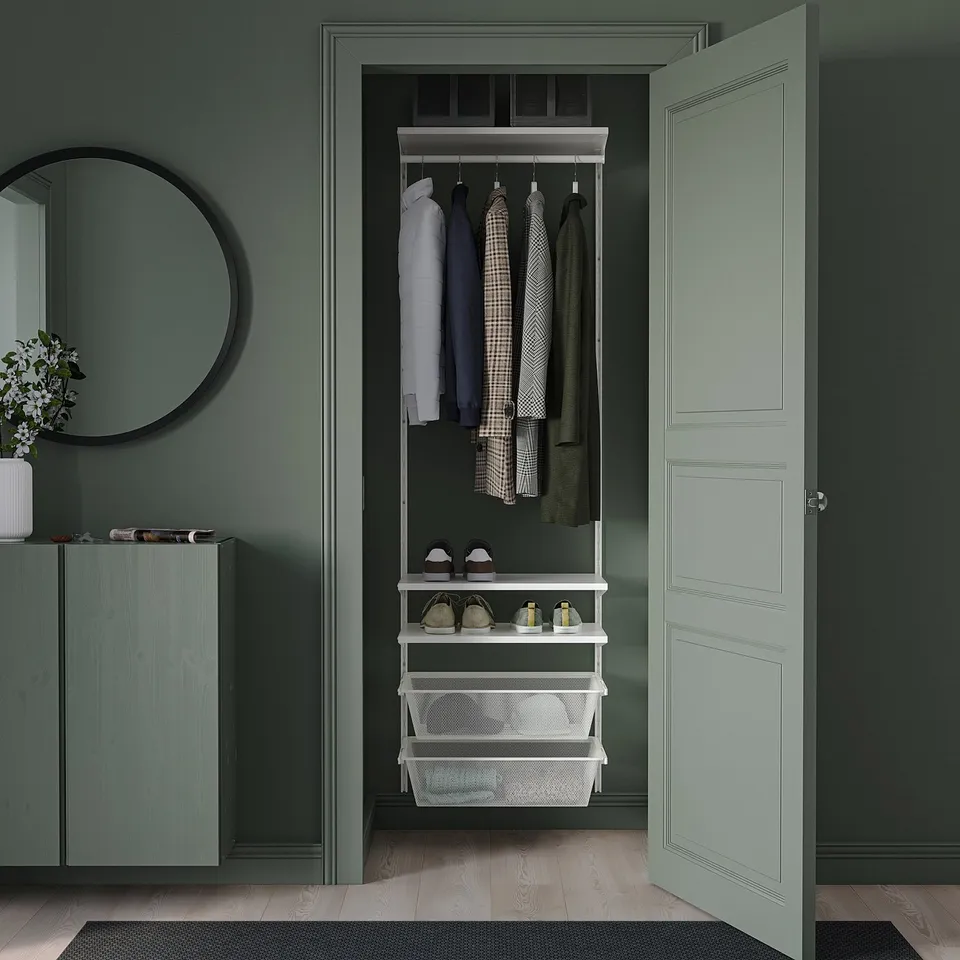 BOAXEL storage system in white with baskets & rail, in sage green walk-in closet with mirror & shoe cabinet.