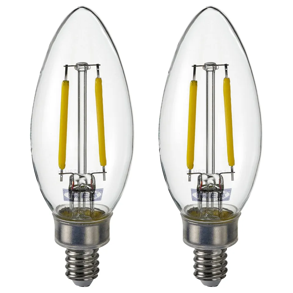Two clear SOLHETTA bulbs with yellow coiled filaments, round glass shape, silver base.